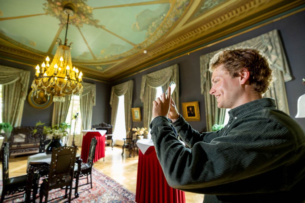 Geels maakt een foto van een chique stijlkamer met prachtig plafond en een mooie kroonluchter