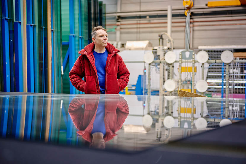 Rutger Snoek kijkt geïnteresseerd rond in de glasfabriek.